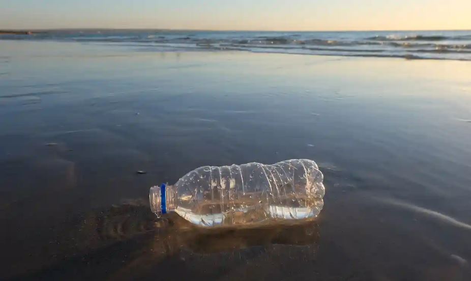 plastic bottle trash left on a beach 